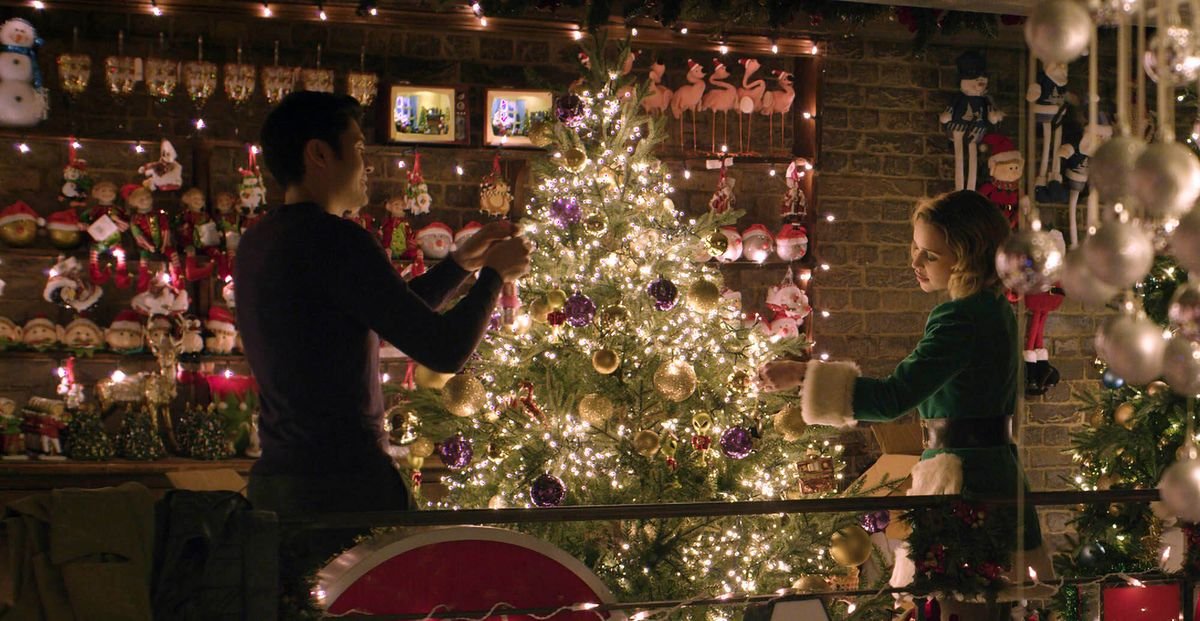 The two lovebirds, lit up by holiday decorations.