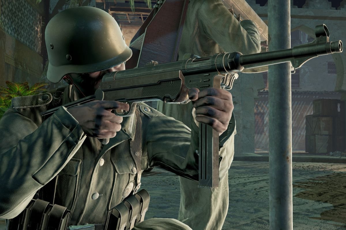 A German soldier in WWII lines up a shot with an MP-44. Behind him is another soldier with a Panzerfaust.