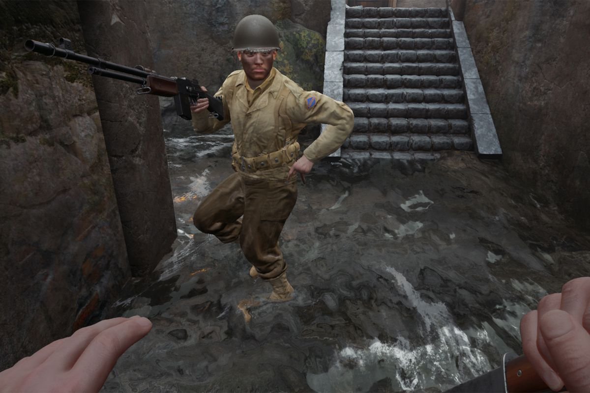 An American soldier in WWII reloading a BAR as he stands in a sewer.