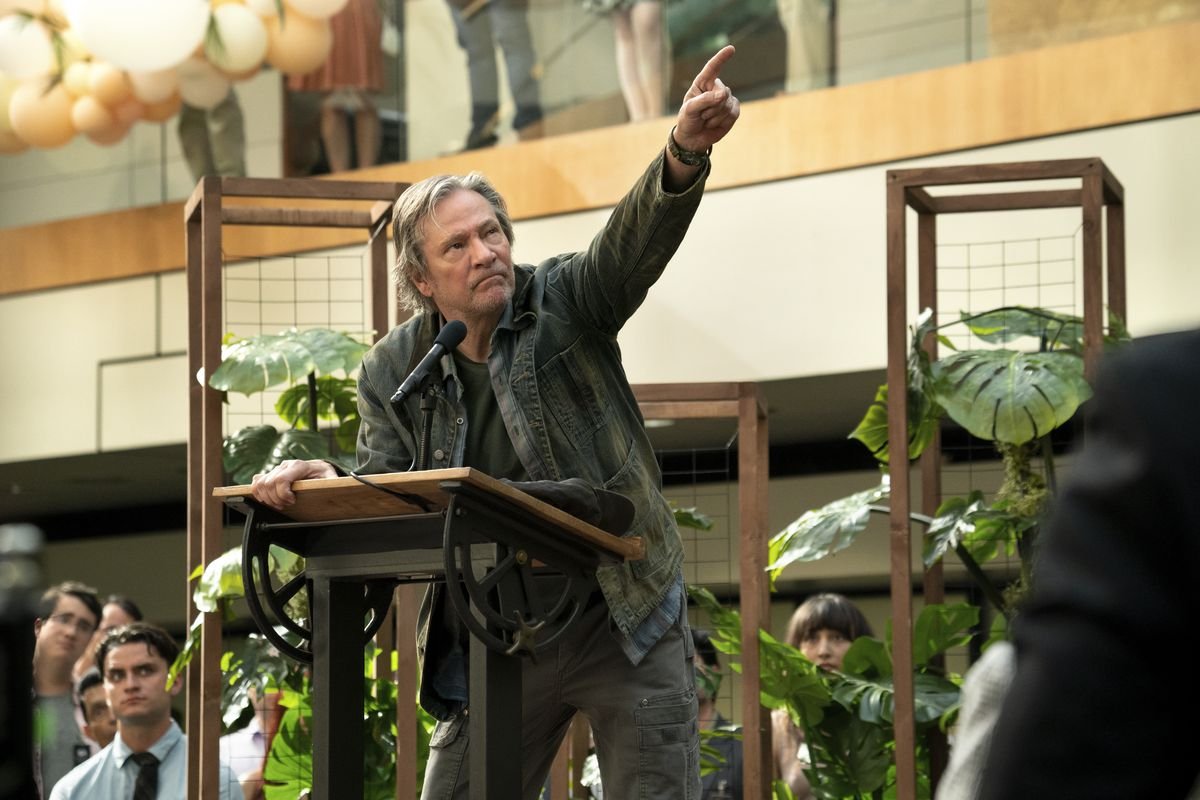 Chris Cooper, standing at a podium, points upward in season 2 of Amazon’s Homecoming