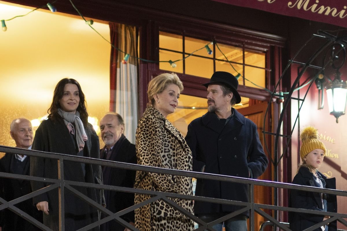 a group of people stand on a balcony