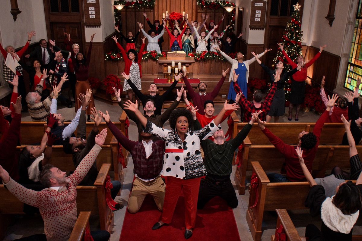 a group of people singing in christmas on the square