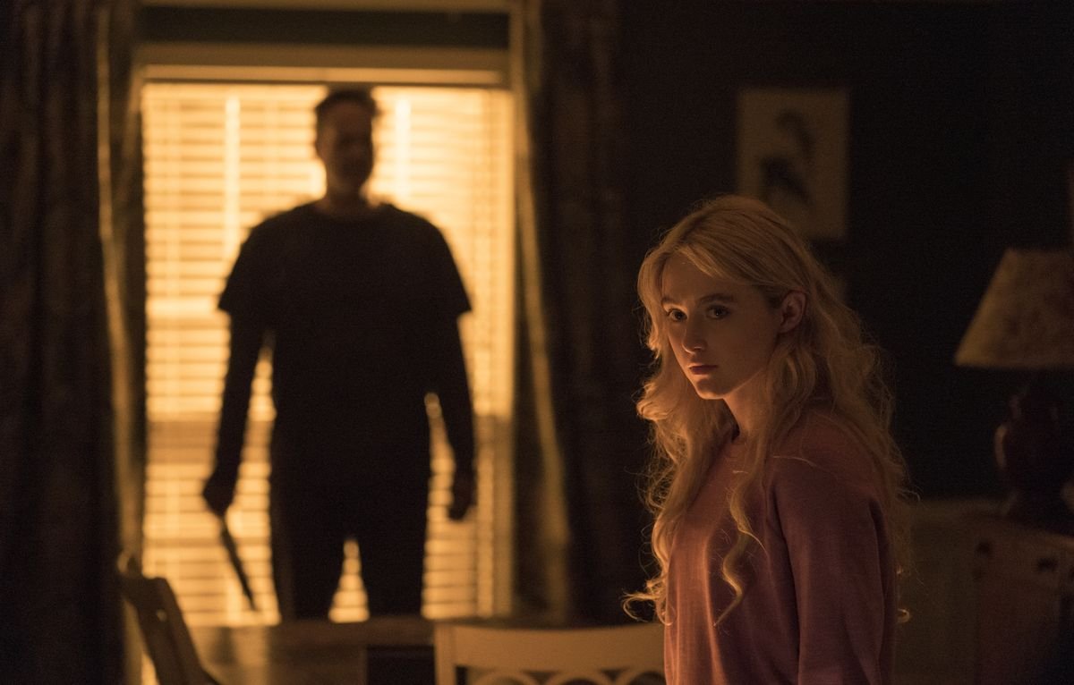 Vince Vaughn looms silhouetted against a window, holding a knife, as Kathryn Newton sits in the foreground in Freaky