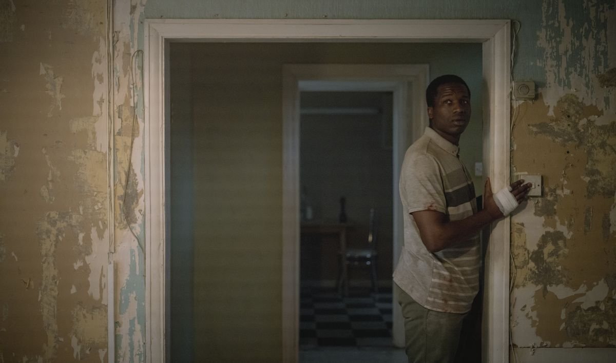 Sudanese refugee Bol (Sope Dirisu) cautiously turns on the lights in a room with ragged, peeling walls in the Netflix movie His House