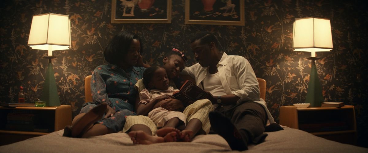 The Emory family curls up together on a bed in Amazon Studios’ Them