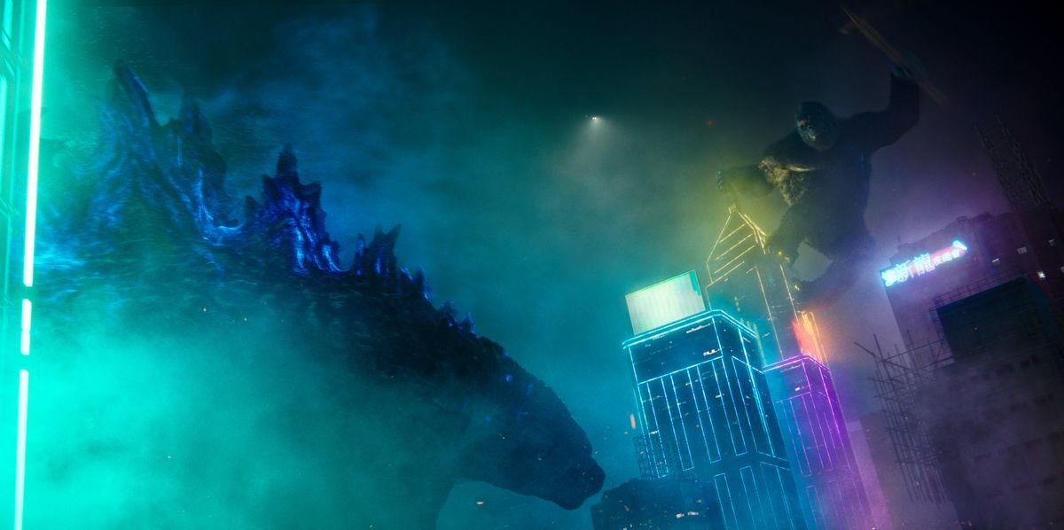 King Kong overlooks Godzilla atop a neon skyscraper at night in Godzilla vs. Kong