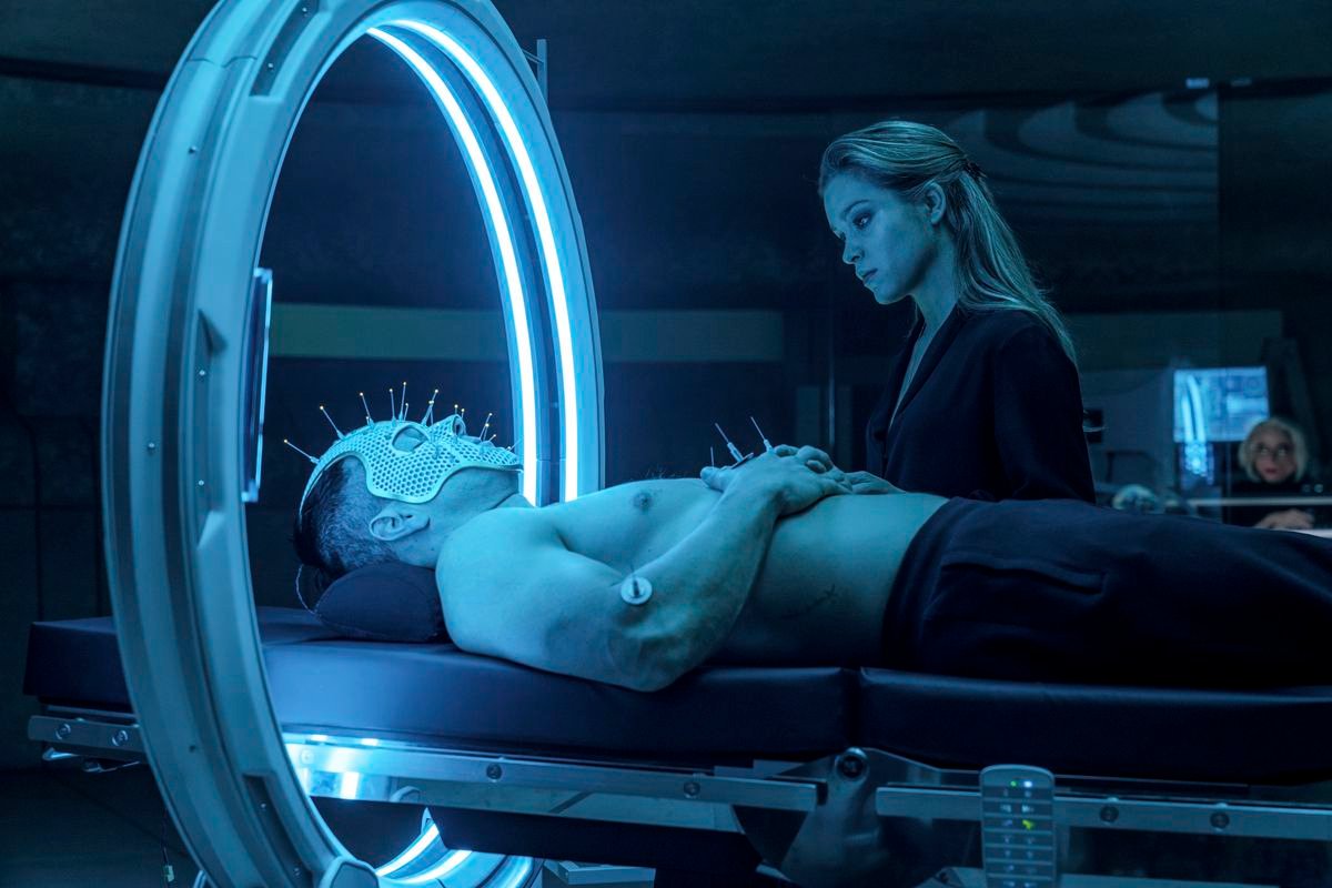 Okay, you got me on this one. Uh, a shirtless Mark Wahlberg is lying on his back on what looks like a hospital bed, wearing a mesh face mask covered with spikes topped with LEDs? And his head is through some kind of big ring lined with blue florescent lights? And Sophie Cookson is looking on a little judgmentally? Anyway, this happens in Infinite.