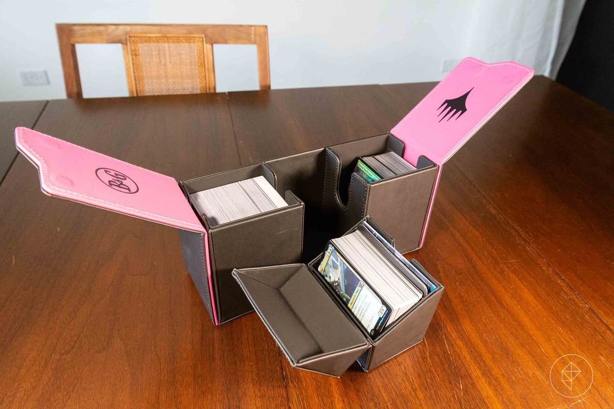 A pink and black deck box with stitched sides.