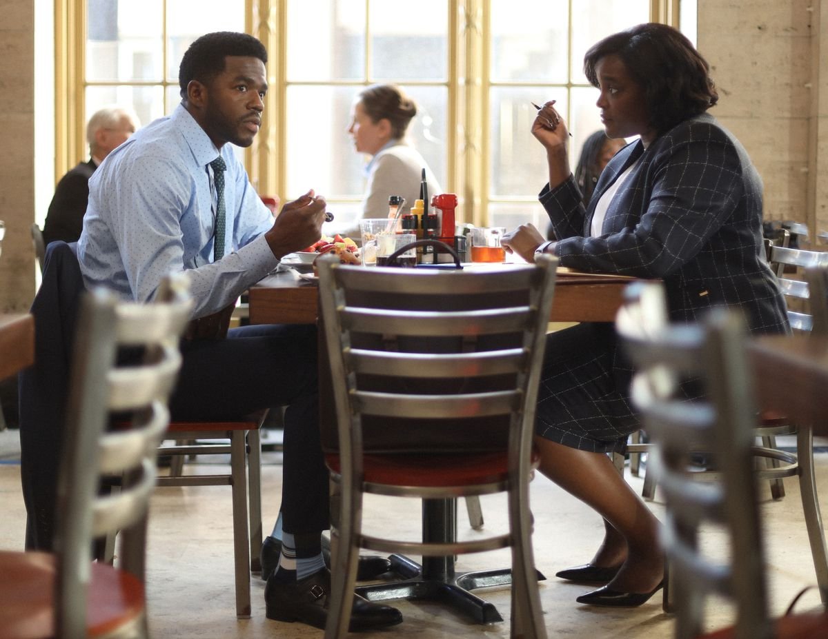 Two city officials sit at a restaurant and talk