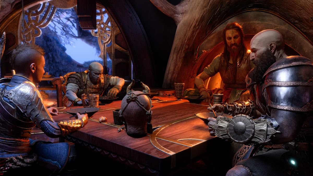 Atreus, Brok, Mimir, Tyr, and Kratos sit around a square wooden table, eating stew out of bowls, in God of War Ragnarök