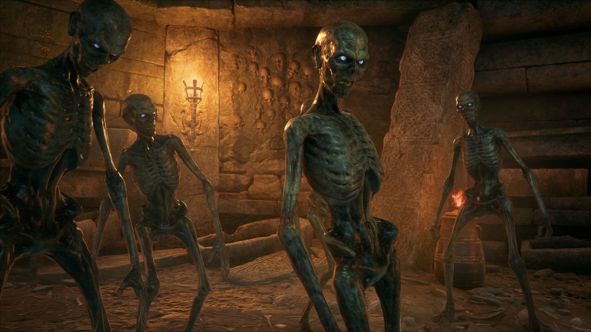 a group of inferi, skeletons with glowing eyes, walk to the right of the camera in a dungeon in Hogwarts Legacy