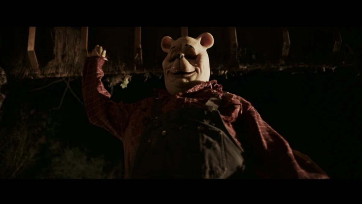 Pooh (Craig David Dowsett) lunges upward to stab an off screen victim in Winnie the Pooh: Blood and Honey