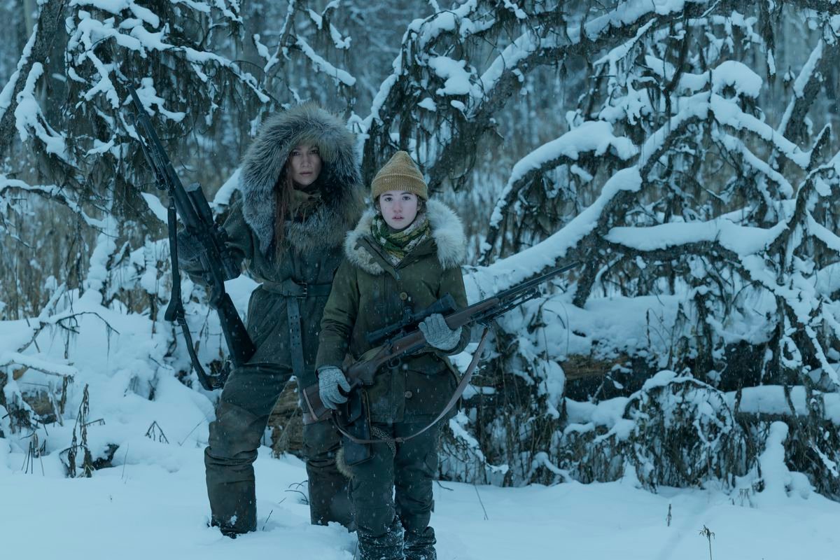 Jennifer Lopez and Lucy Paez hold rifles in the snow in The Mother.