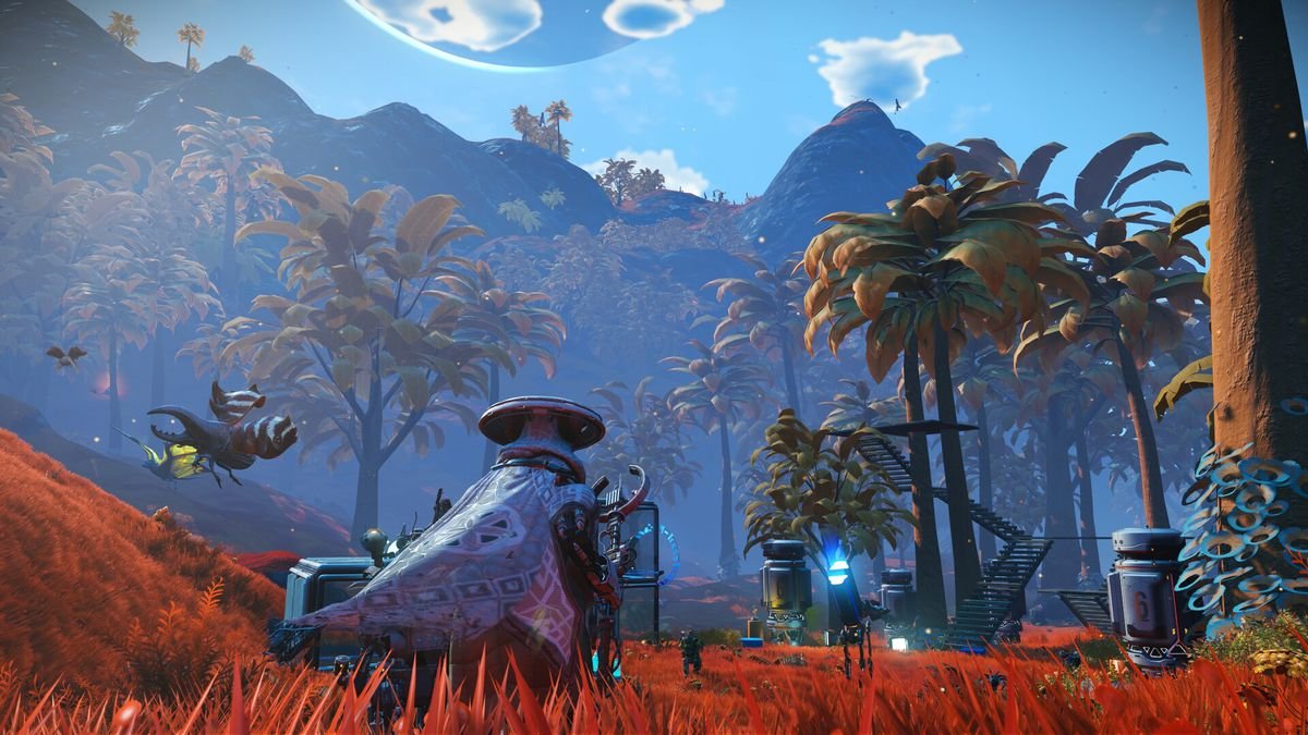 An explorer wearing a purple cape wades through tall, orange grasses, on their way to an outpost in No Man’s Sky