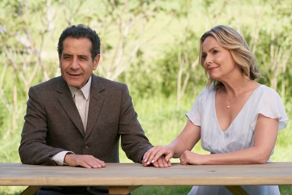 Monk (Tony Shalhoub) sitting and holding hands with the ghost of his wife Trudy (Melora Hardin) 