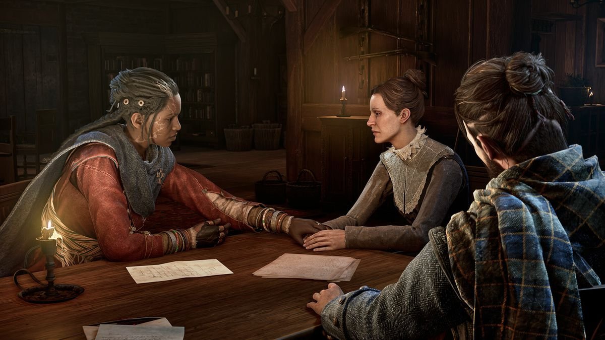 Antea and Red talk to a woman around a candlelit table in Banishers: Ghosts of New Eden. Antea holds the woman’s hand