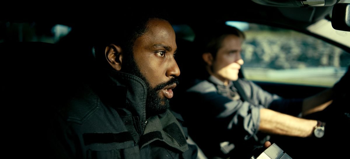 John David Washington and Robert Pattinson sit in a car in Tenet