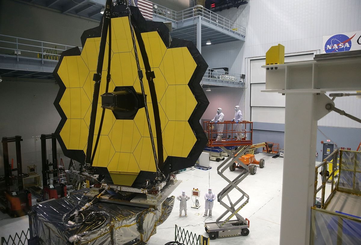 The mirrors of the James Webb Space Telescope being lifted up in a warehouse