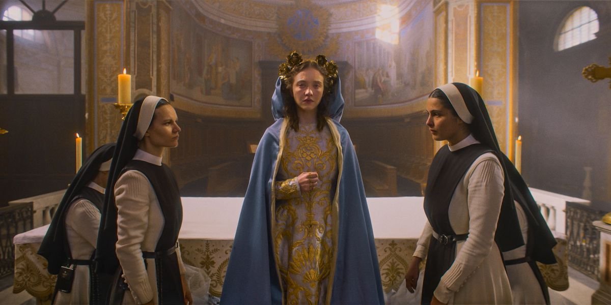 Sydney Sweeney in Immaculate dressed like Mary with nuns flanking her on either side 