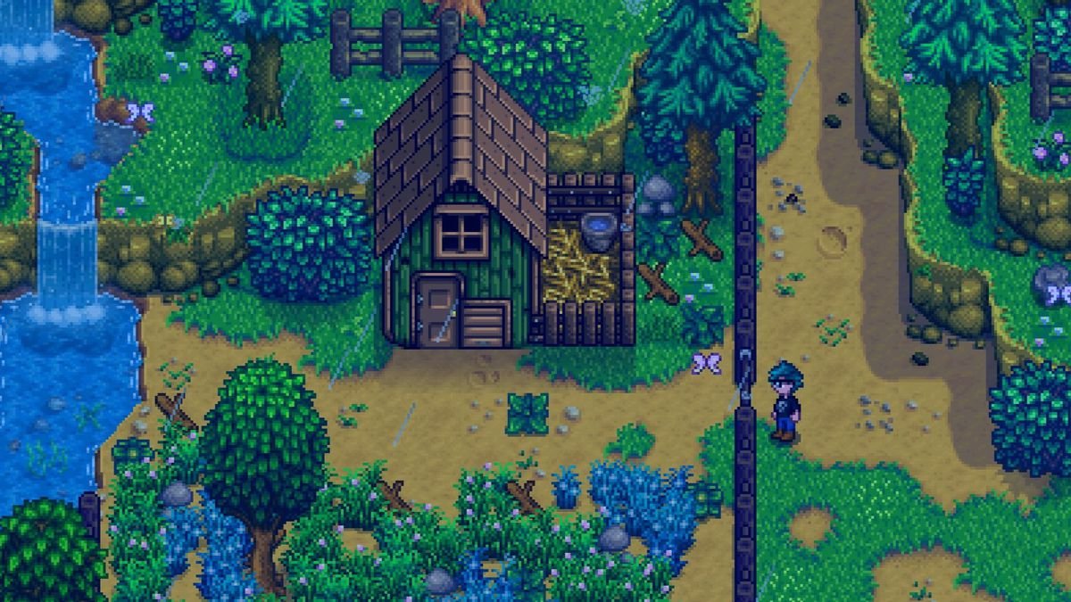 A Stardew Valley player characters standing at the fence to the chicken coop on the Meadowlands Farm. It’s surrounded by wild grass and blue grass.