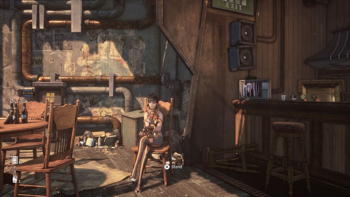 EVE, the protagonist of Stellar Blade, sits in a chair in one of the game’s resting places, which looks like an abandoned coffee shop