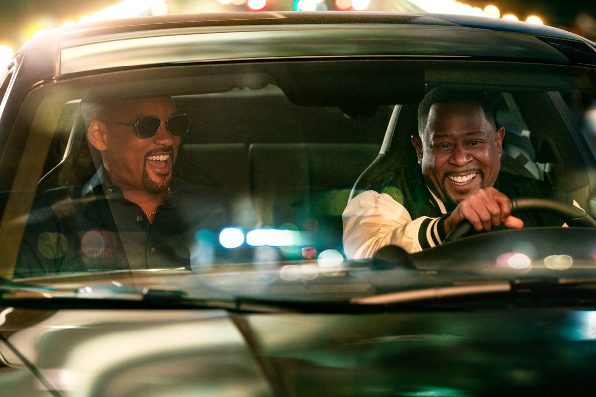 Will Smith sits in the passenger seat as Martin Lawrence drives as the two laugh in a scene from Bad Boys: Ride or Die.