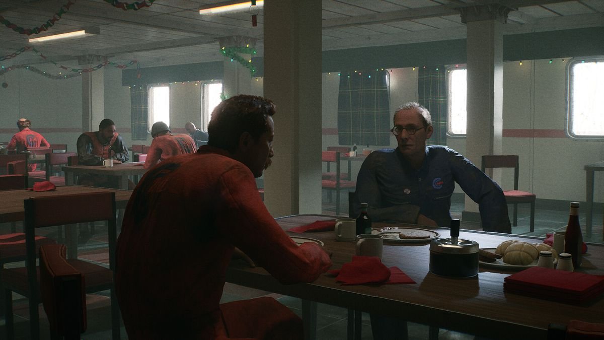 The crew members of an oil rig chat amongst themselves in a mundane-looking mess hall. They are wearing uniforms to traverse the oil rig. The scene is calm.