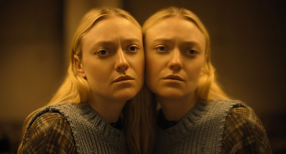 Mina (Dakota Fanning) stands with her cheek pressed up against a mirror in Ishana Night Shyamalan’s The Watchers